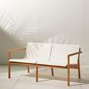 Kaplan Wooden Outdoor Sofa in natural light with shadow of palm leaves
