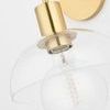 Side angle featuring gold arm and socket with clear glass shade and visible bulb filament