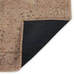 Folded corner exposing black backing and edge stitching on Morelli Alani rug