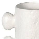 Close-up showing top opening and paired spherical protrusion on matte white textured metal vase