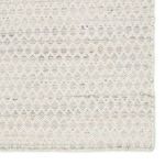 Close-up of rug edge showing stitched binding and detailed handwoven design