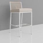 Sabbia Counterstool shown at slight side angle against gray wall highlighting footrest detail and frame structure