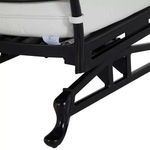 Close-up of black lounge chair leg with a curved foot design and part of black frame