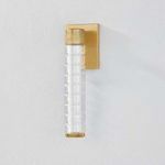 Castor Bath Sconce with thick ridged glass tubes and aged brass rectangular backplate in vertical orientation
