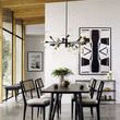 Pellman Chandelier hanging over black dining table in modern room with wood ceiling and large window