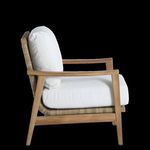 Side profile highlighting chair’s curved armrest and thick white cushion depth.