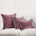 Three pillows in different sizes arranged on a white couch for size reference