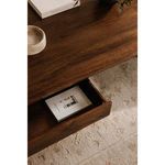 Detail of partially opened drawer containing a book, showcasing storage functionality and wood texture.