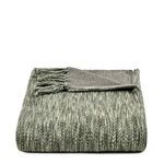 Folded handwoven throw blanket in natural gray with fringed ends and soft textured cotton weave