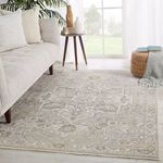 Alain Medallion Rug styled in a light and airy living room with sofa, side table, and pouf