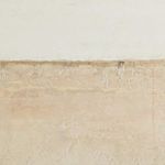 Close-up focusing on the horizontal border between off-white and beige textured areas