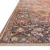 Close angled view of rug corner showing detailed stitched edges and the border’s dark marine blue floral design