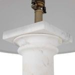 Close-up of the upper marble base connecting to the lamp socket and antique brass hardware
