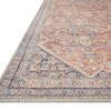 Low angled edge view showing detailed border design with intricate weaving and muted color palette