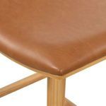 Detailed corner view of seat upholstery stretched over plywood base