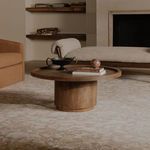 Cohen coffee table styled in living room between neutral sofas on patterned rug