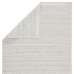 Back folded over showing rug's reverse side with the same light gray and ivory pattern