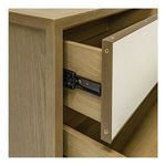 Nightstand in modern bedroom with textured beige wall and woven gray area rug