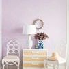 Styled room context with Astor side table between two white chairs, floral arrangement, lamp, and decorative wall