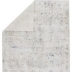 Back of rug partially folded to reveal neutral gray backing