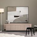 Mixed media painting with muted earth tones hanging above modern light wood cabinet in styled room