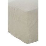 Straight rear view of slipcover ottoman showing subtle tailored seam line in beige fabric