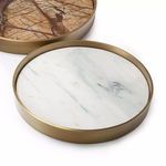 Close-up of large round brass tray with white marble inlay and subtle gray veining