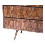 Close-up on O2 dresser drawer fronts showing geometric carved details and tapered leg