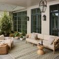 Saylor Mosaic Field Rug used on covered outdoor patio with beige couch and wooden side tables