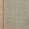 Close-up of Polly Spa rug corner on light hardwood floor showing grid pattern detail
