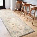 Runner-sized Ivory Rosette rug placed in kitchen bar area with high wooden stools, showing shape and scale