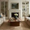 Earl pillow styled on beige sofa in a living room with fireplace and neutral decor