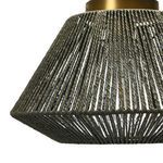 Close-up of woven paper rope texture on ceiling light shade with brass details