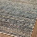 Close-up of rug surface showing subtle horizontal striations in muted earth and gray tones on hardwood floor