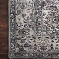 Close-up corner of Layla Taupe Stone Rug showing detailed floral border pattern on dark wood floor