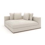 Front-right angled view displaying the soft texture and pillow arrangement on the chaise