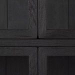 Close-up of textured black oak wood grain at the intersection of cabinet doors