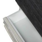 Close-up showing inside of a small upper drawer with clean white interior and dark wood top edge