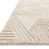 Angled close-up emphasizing wool pile texture and three-dimensional pattern depth on rug edge