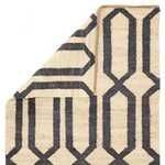 Corner of Luxor Natural Trellis rug folded to show flatweave texture and backside pattern in beige and blue