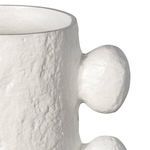 Side view close-up focused on rounded protrusion and texture of matte white Sanya Metal Vase