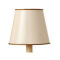 Front view of cream tapered shade with gold rims and crackled finish on a short candle holder