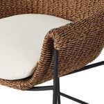 Close-up of rolled arm detail with woven texture and black iron arm support