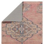 Backside of rug flipped to reveal gray traction backing for hard surface floors
