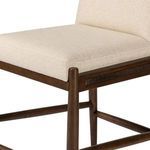 Close-up of seat cushion showing smooth linen upholstery and wood frame edges