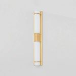 Tottenville wall sconce mounted on a light grey wall showing lit shades with soft white glow