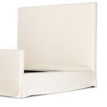 Footboard and side panel linen slipcover corner with soft folds and rounded edge