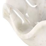 Close-up focusing on exterior wave edge curvature and glossy marble surface