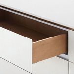 Open drawer showing natural wood interior contrasting with white exterior finish