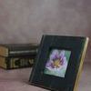 Natalia Picture Frame styled on pink surface with purple flower photo and books in blurred background